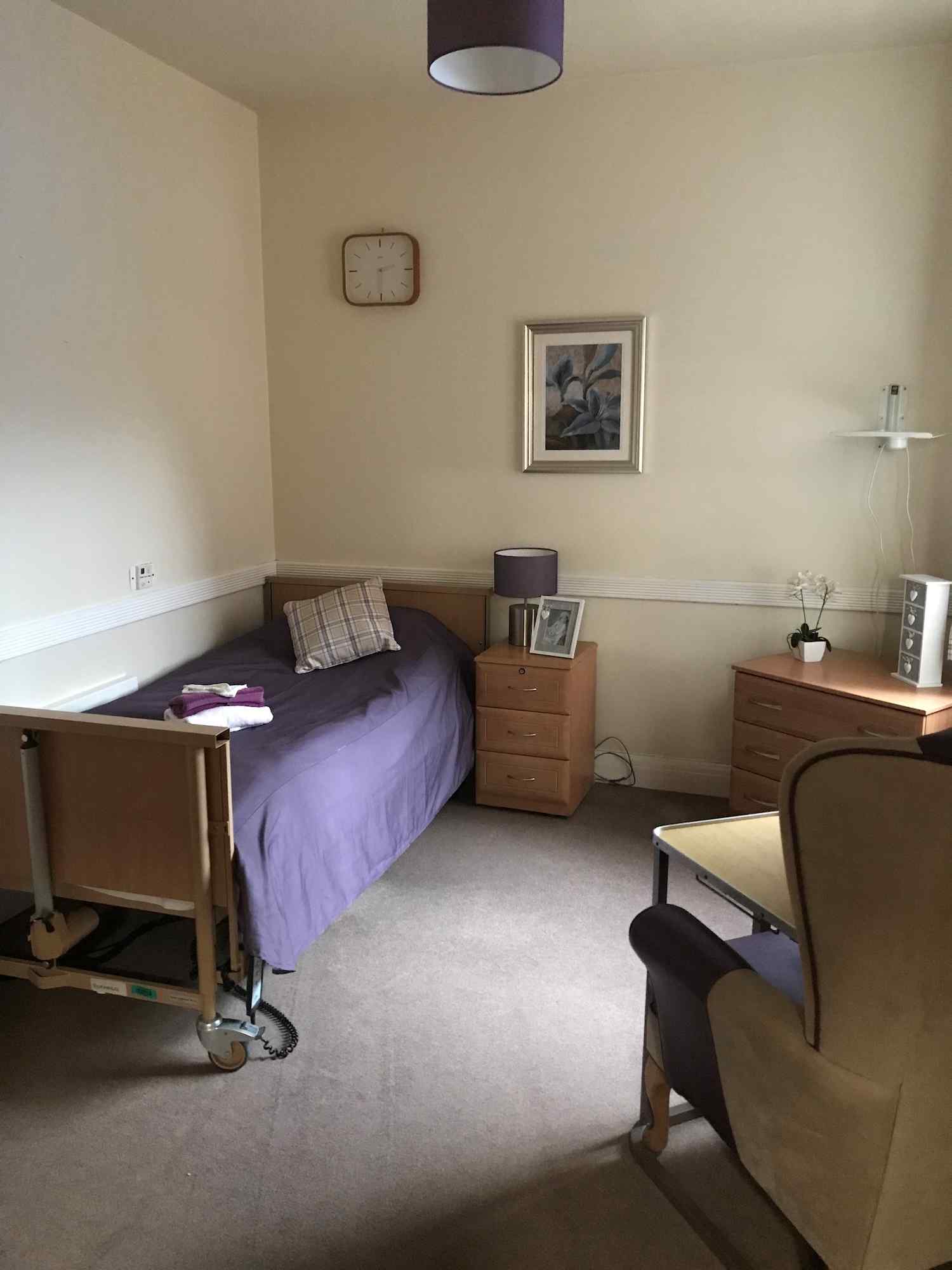 bedroom with a purple duvet on the bed