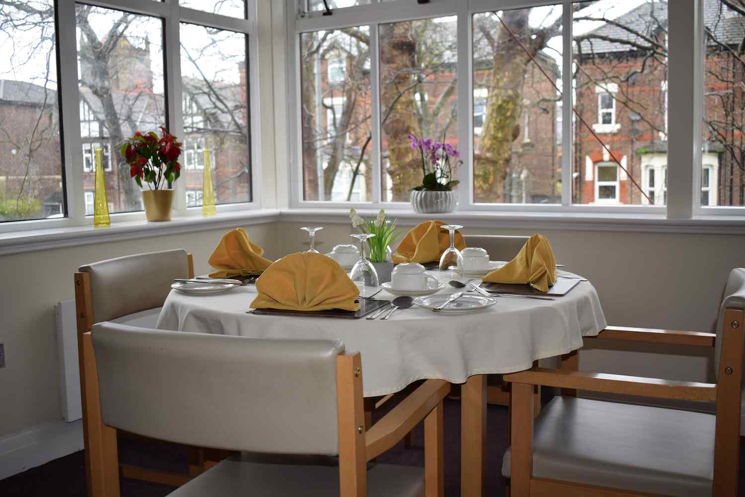 one of our dining tables setup with cutlery and yellow hankerchiefs